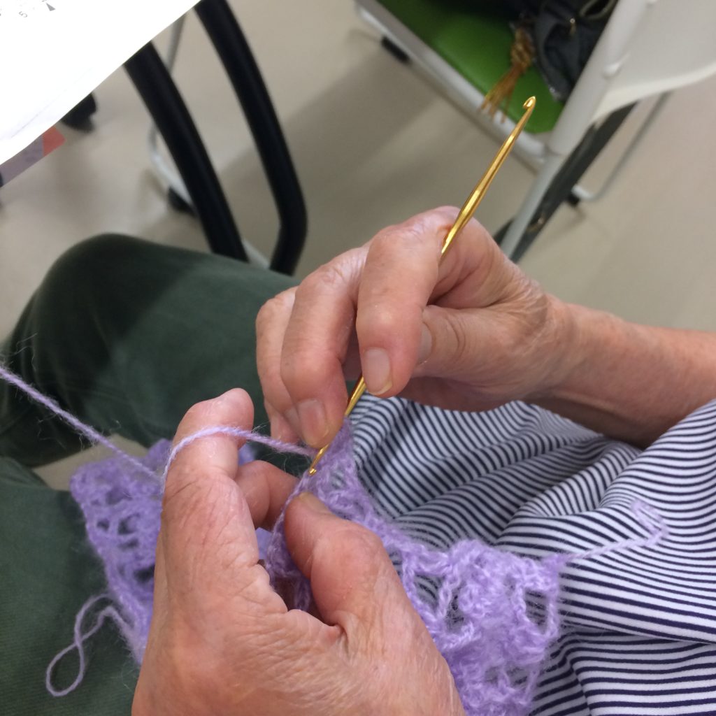 秋の作品展に出すカーディガンの袖を編んでいる